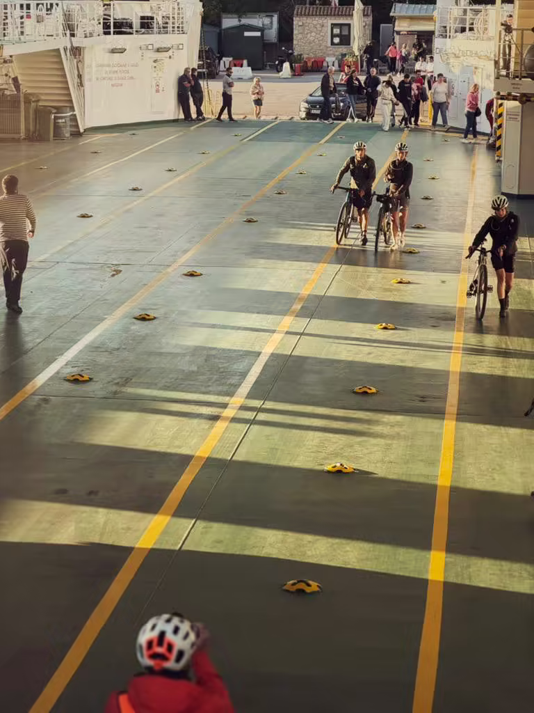 Riders rolling off ferry at sunset